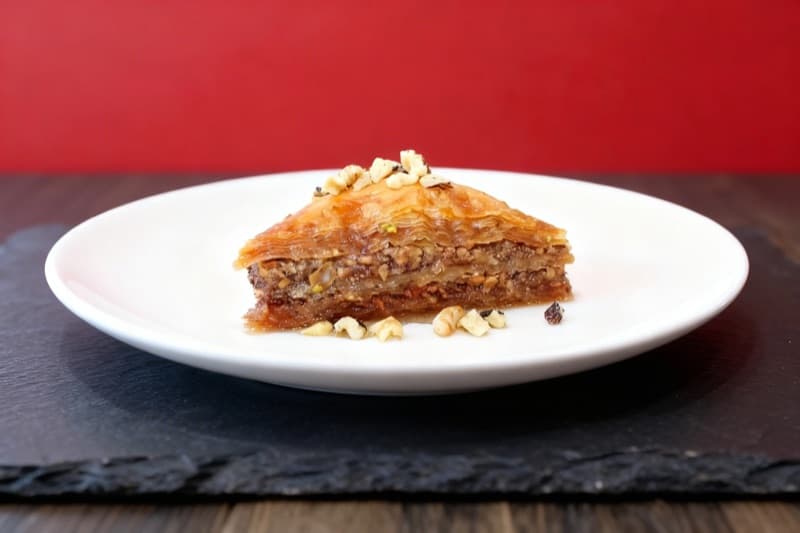 After: Baklava transformed from messy tray to slate surface with red backdrop