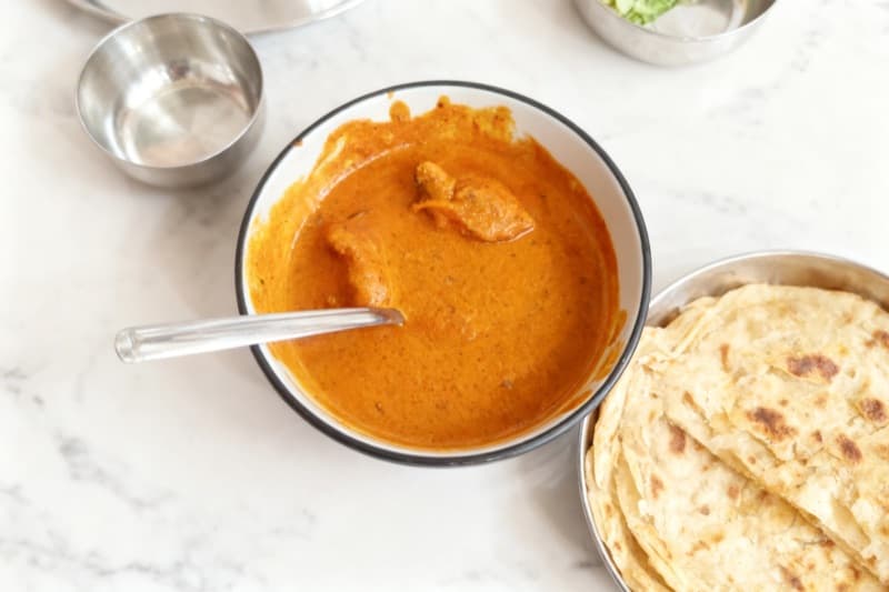 After: Butter chicken transformed from crowded table to marble surface