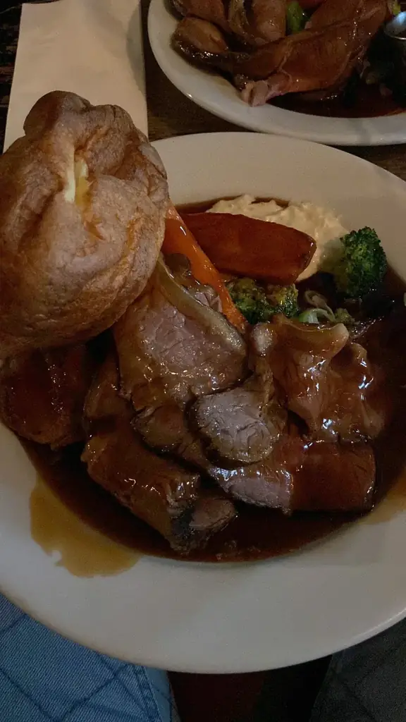 A roast dinner shot on a phone: flat lighting, messy plating