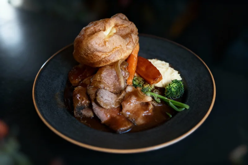 Dark Elegant Overhead food photography style by MenuPhotoAI - Sophisticated overhead perspective with dark plate and warm, natural tones