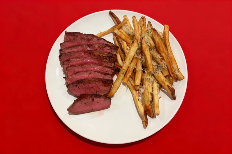 After: Steak and fries transformed from dark kitchen to bold red backdrop